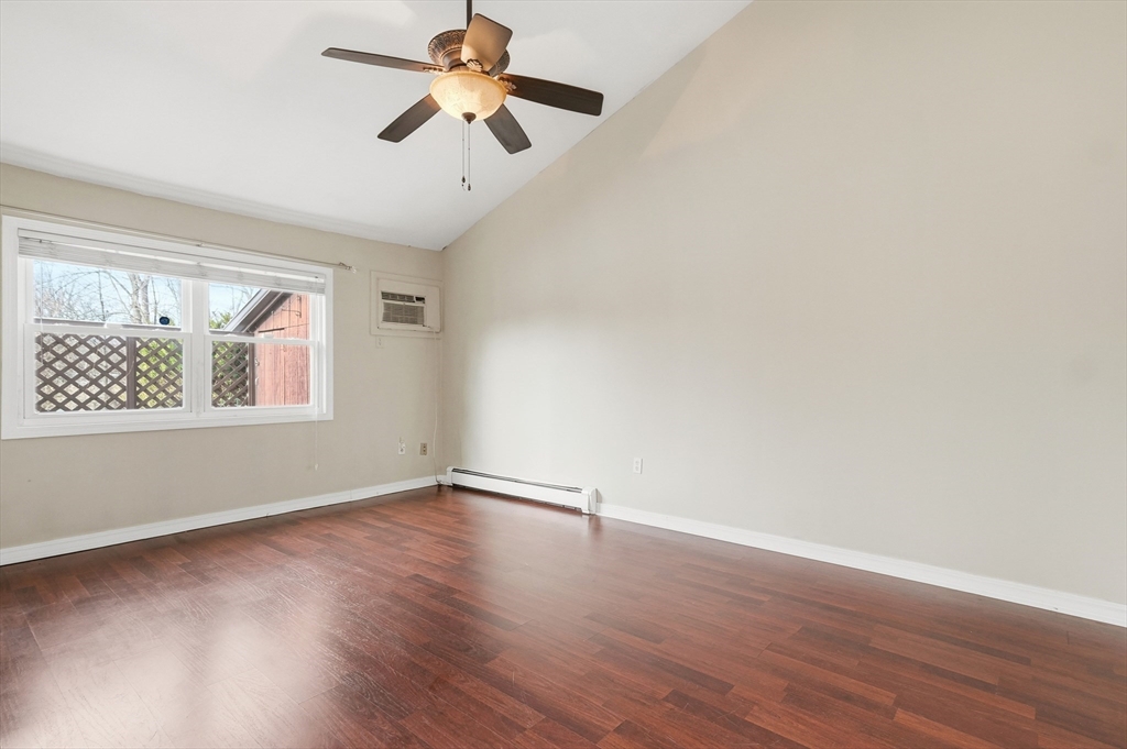 6 Adams Court, Unit 6 Amesbury, MA 01913 - Photo 3 of 22 a view of an empty room with wooden floor and a window