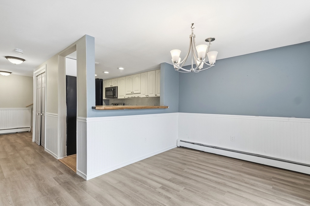 6 Adams Court, Unit 6 Amesbury, MA 01913 - Photo 6 of 22 a view of a kitchen with wooden floor and a kitchen