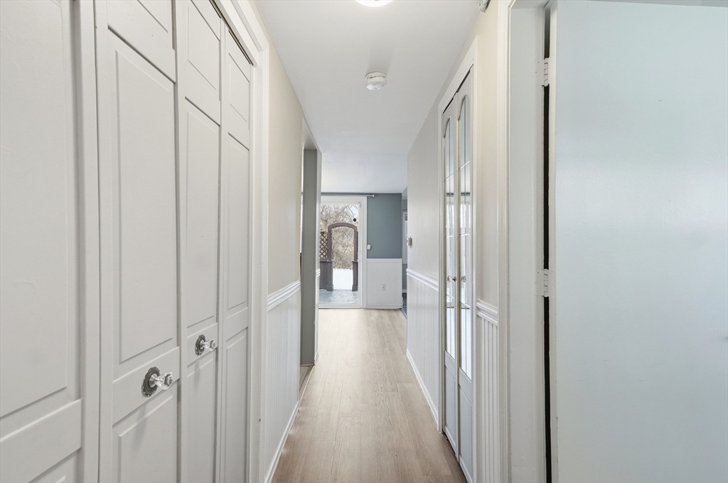 6 Adams Court, Unit 6 Amesbury, MA 01913 - Photo 9 of 22 a view of a hallway with wooden floor and staircase