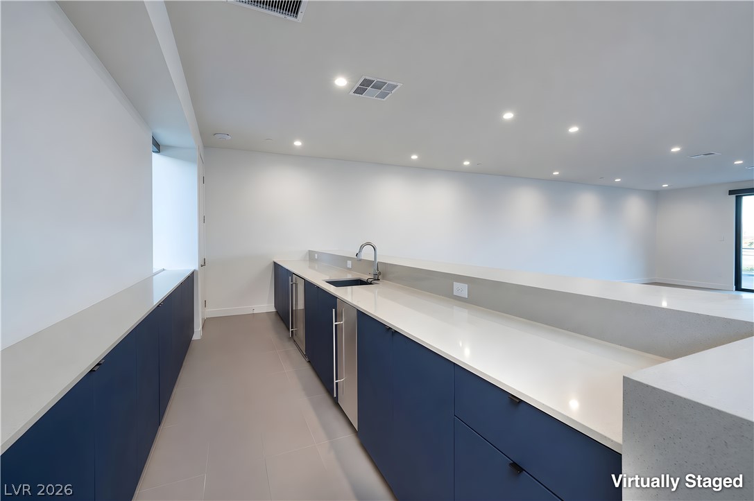25 Falling Ridge Lane Henderson, NV 89011 - Photo 22 of 48 A sleek, modern wet bar with ample counter space and integrated appliances for entertaining.