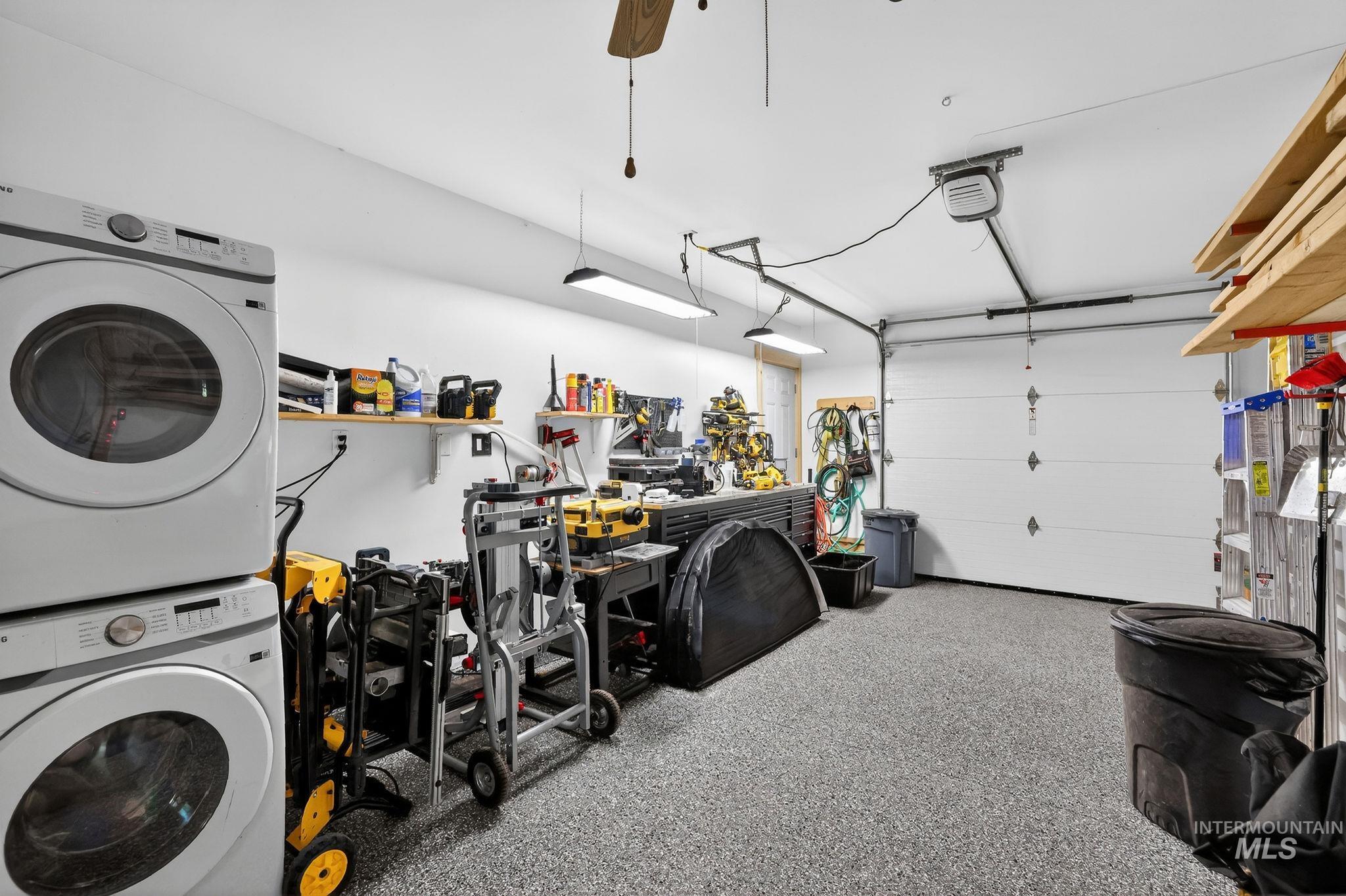 321 Secesh River Road McCall, ID 83638 - Photo 24 of 50 Spacious garage featuring a speckled epoxy floor, white walls, and bright overhead lighting