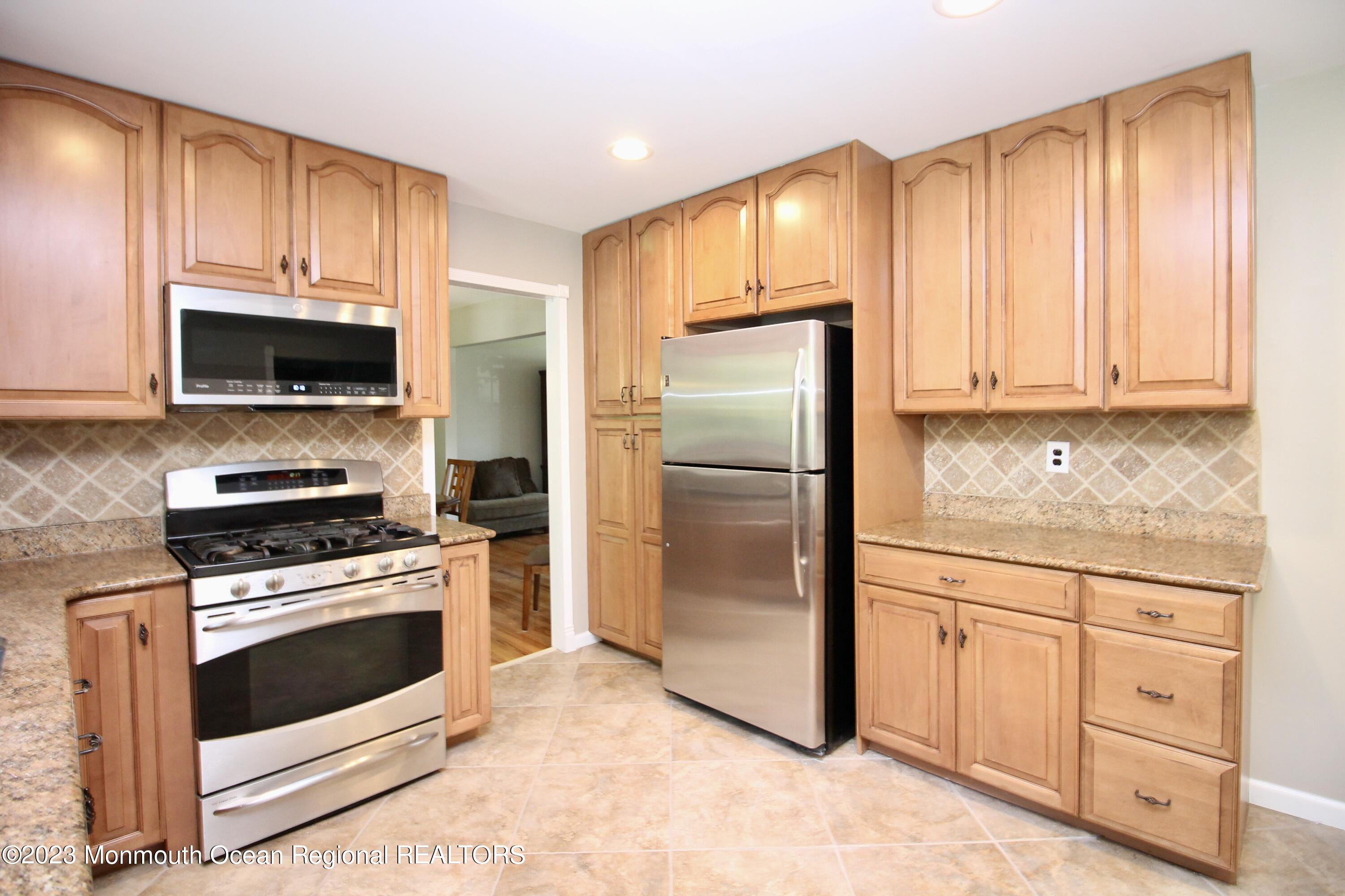 259 Kings Mountain Road Freehold, NJ 07728 - Photo 20 of 61 a kitchen with white cabinets stainless steel appliances and a window