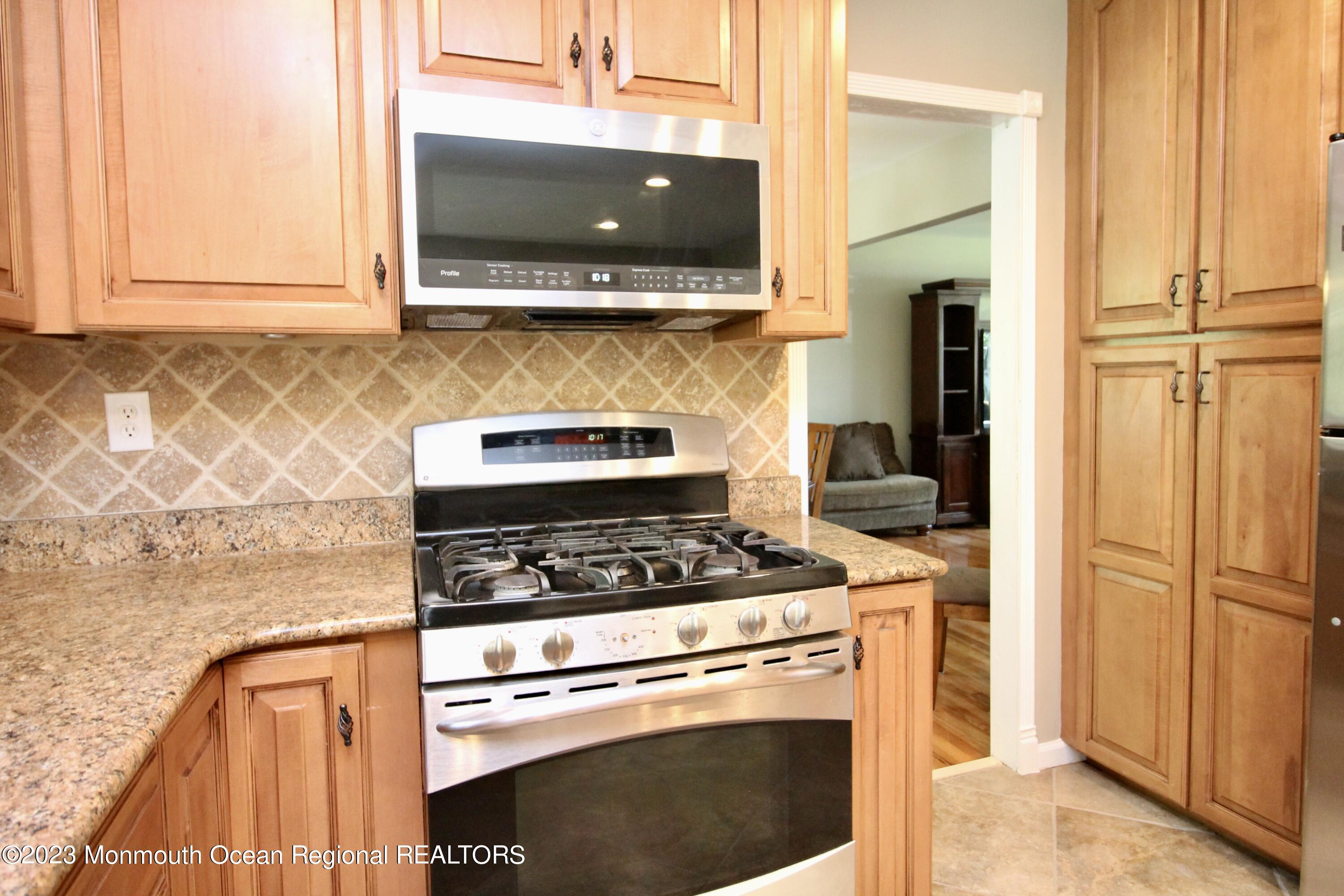 259 Kings Mountain Road Freehold, NJ 07728 - Photo 21 of 61 a kitchen with granite countertop cabinets stainless steel appliances and a counter space
