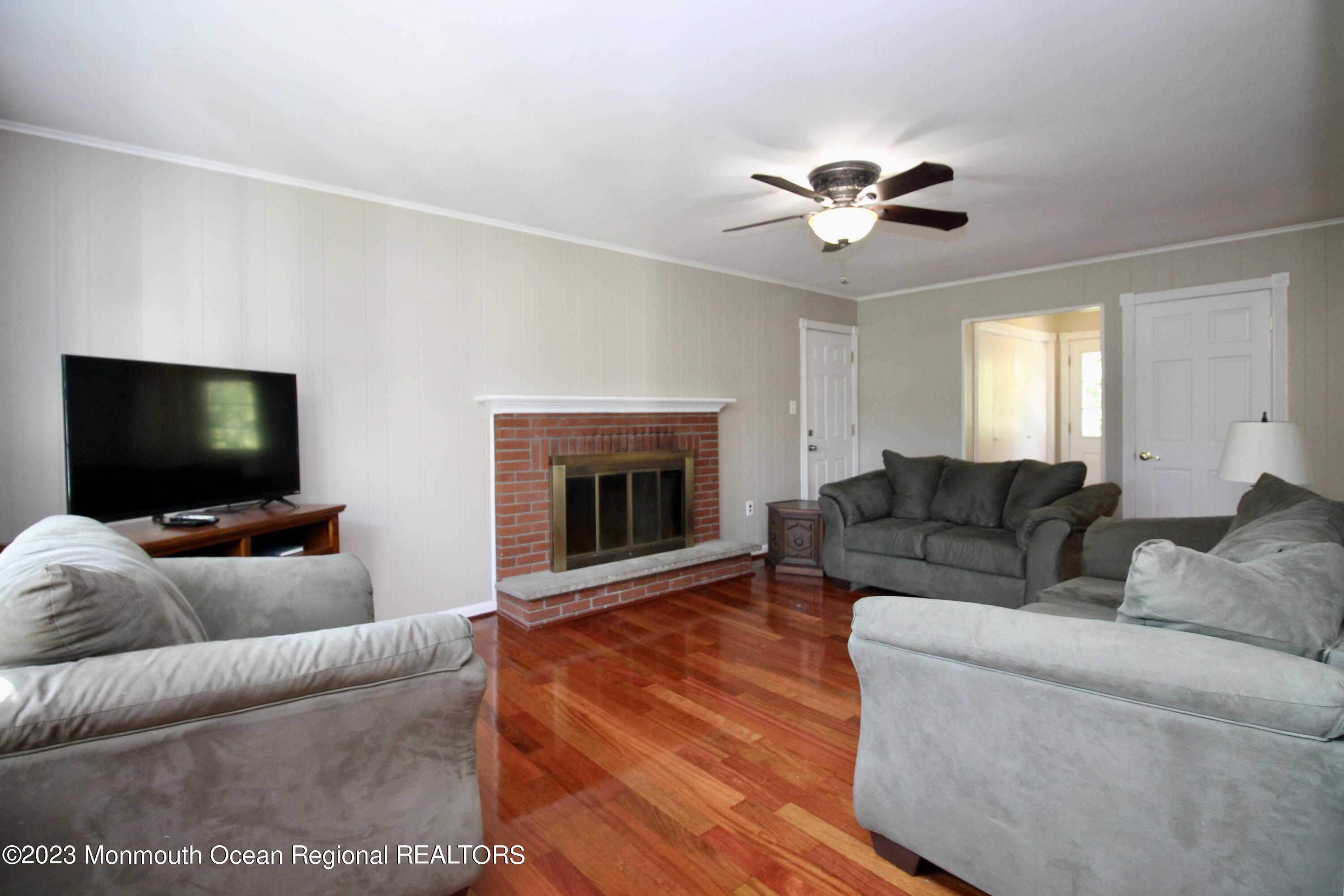 259 Kings Mountain Road Freehold, NJ 07728 - Photo 27 of 61 a living room with furniture and a flat screen tv