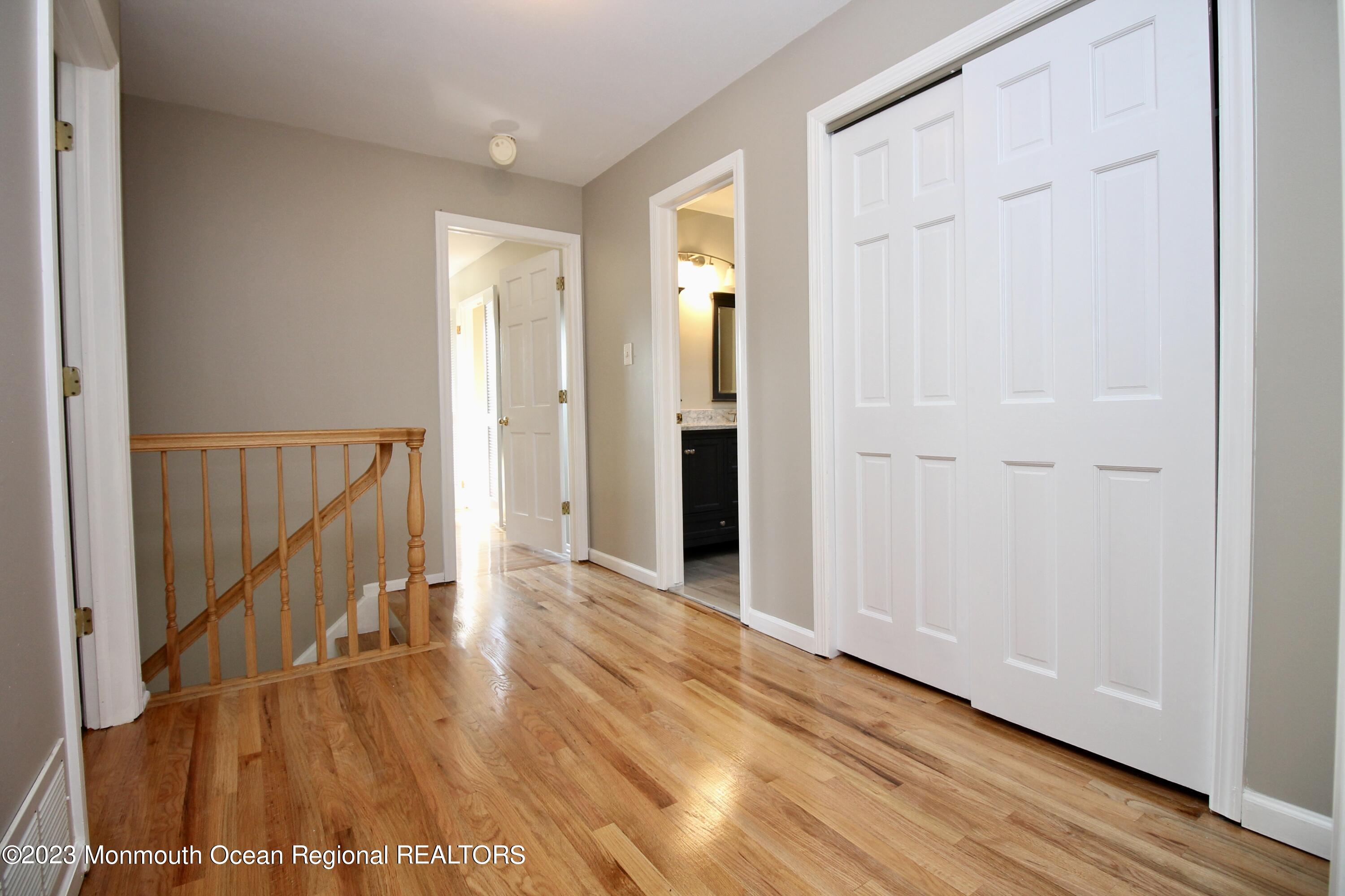 259 Kings Mountain Road Freehold, NJ 07728 - Photo 30 of 61 a view of a hallway with wooden floor and staircase