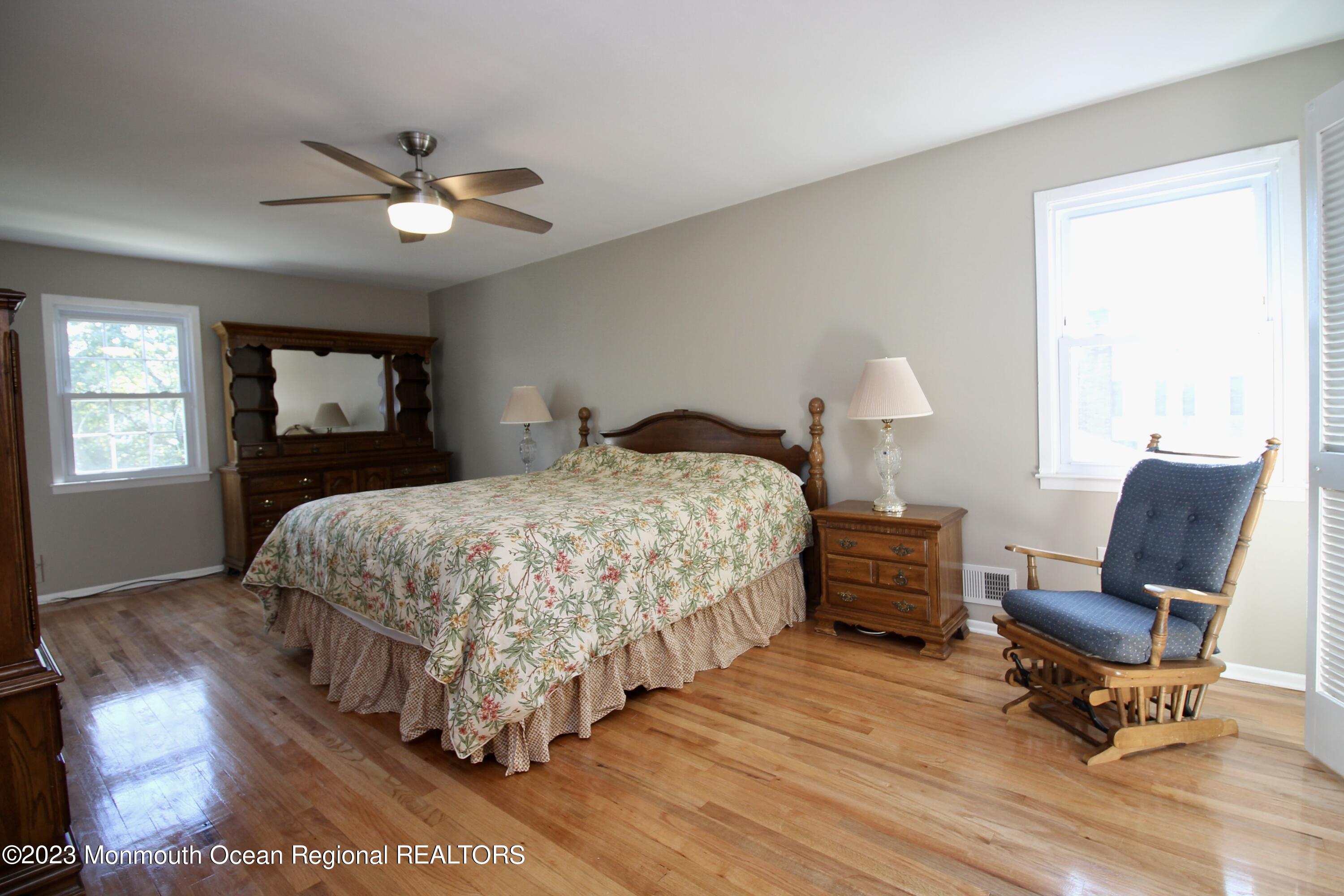 259 Kings Mountain Road Freehold, NJ 07728 - Photo 31 of 61 a bedroom with a bed a chair and potted plant on the dresser