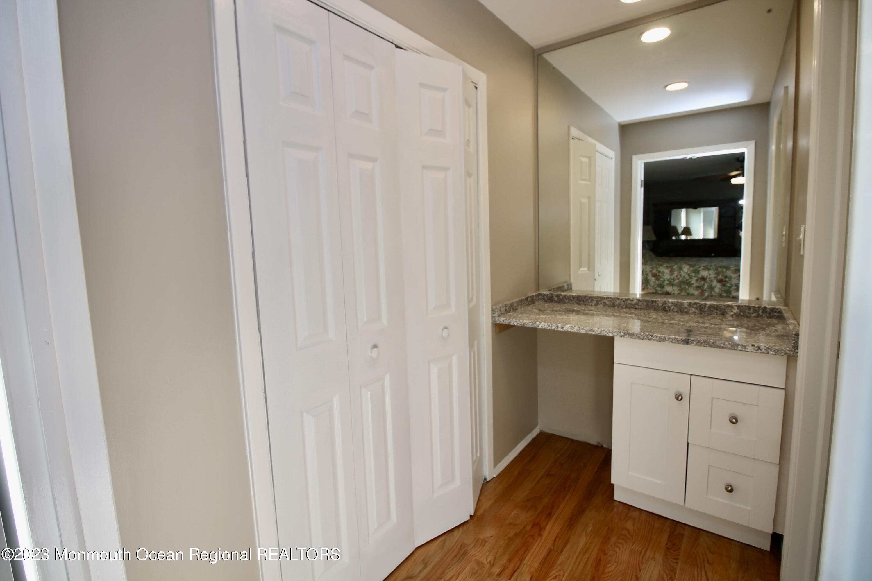 259 Kings Mountain Road Freehold, NJ 07728 - Photo 33 of 61 a bathroom with a granite countertop sink and a mirror