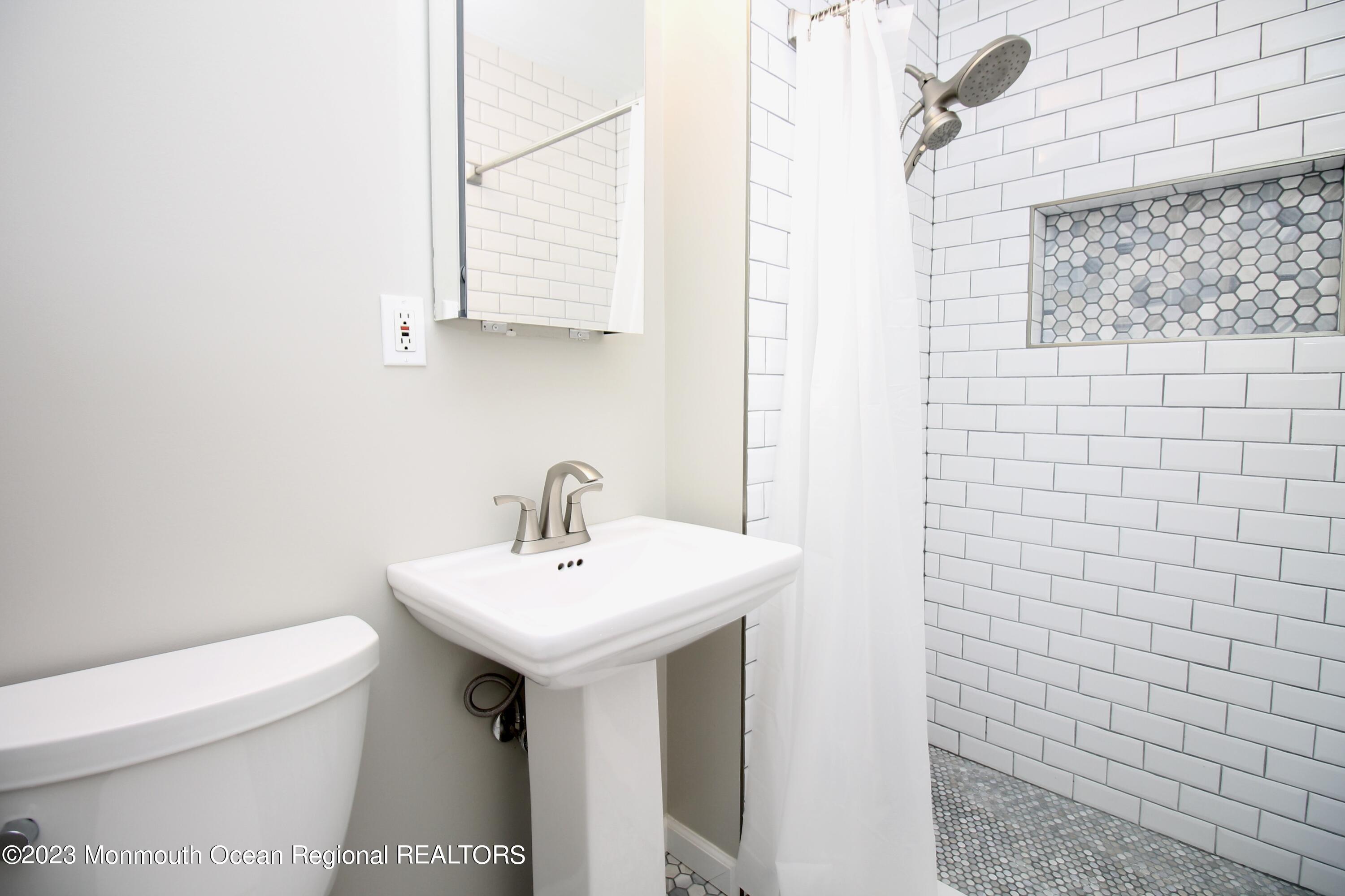259 Kings Mountain Road Freehold, NJ 07728 - Photo 35 of 61 a bathroom with a sink a toilet and mirror