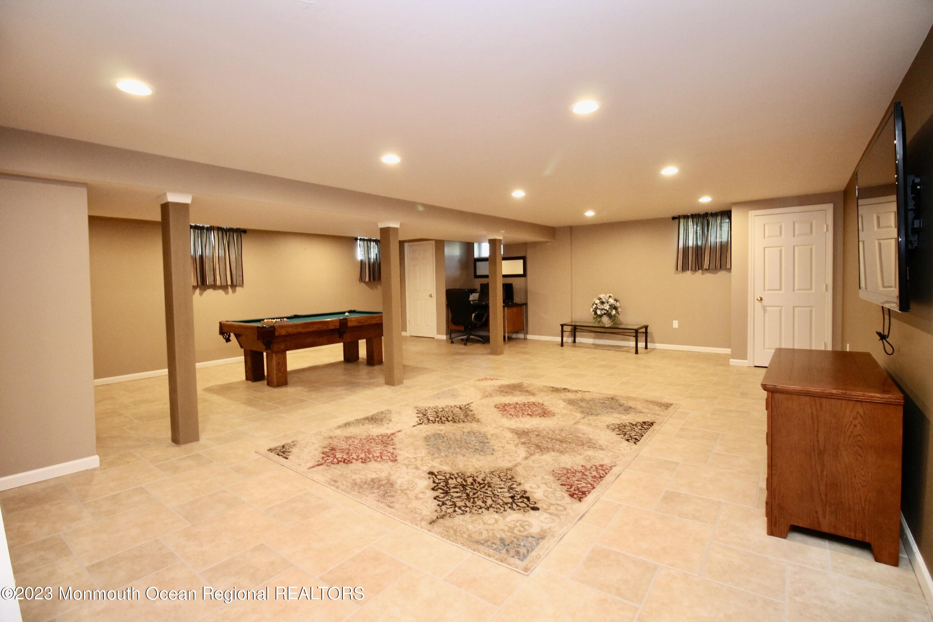 259 Kings Mountain Road Freehold, NJ 07728 - Photo 46 of 61 a view of a livingroom with furniture and a flat screen tv