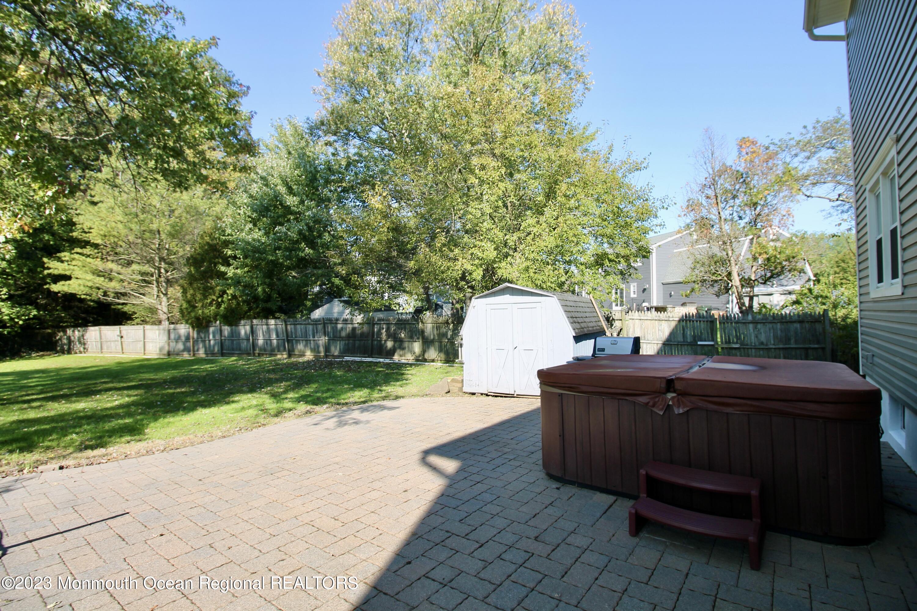 259 Kings Mountain Road Freehold, NJ 07728 - Photo 50 of 61 a view of a back yard of the house and a fire pit