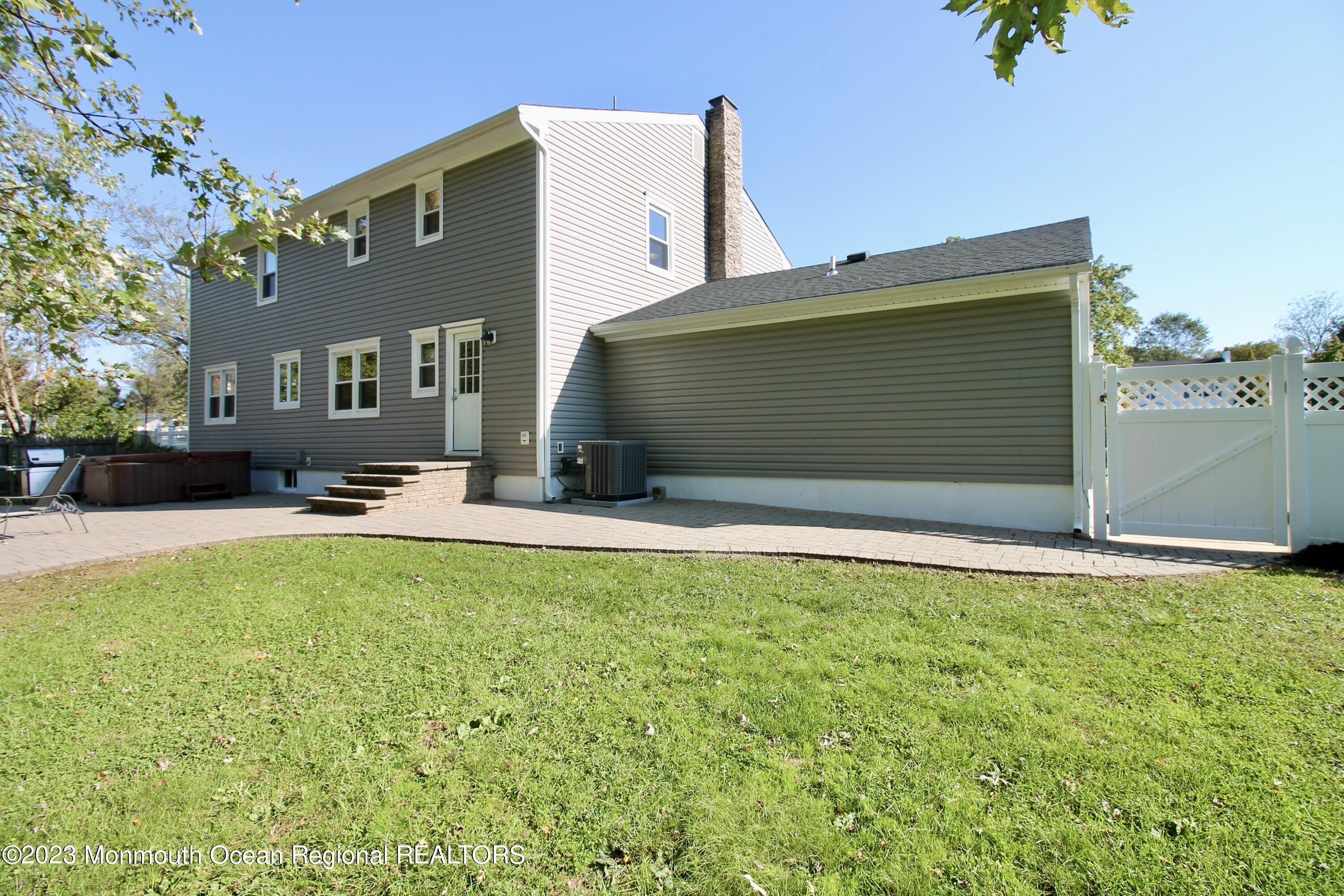259 Kings Mountain Road Freehold, NJ 07728 - Photo 56 of 61 a backyard of a house with table and chairs