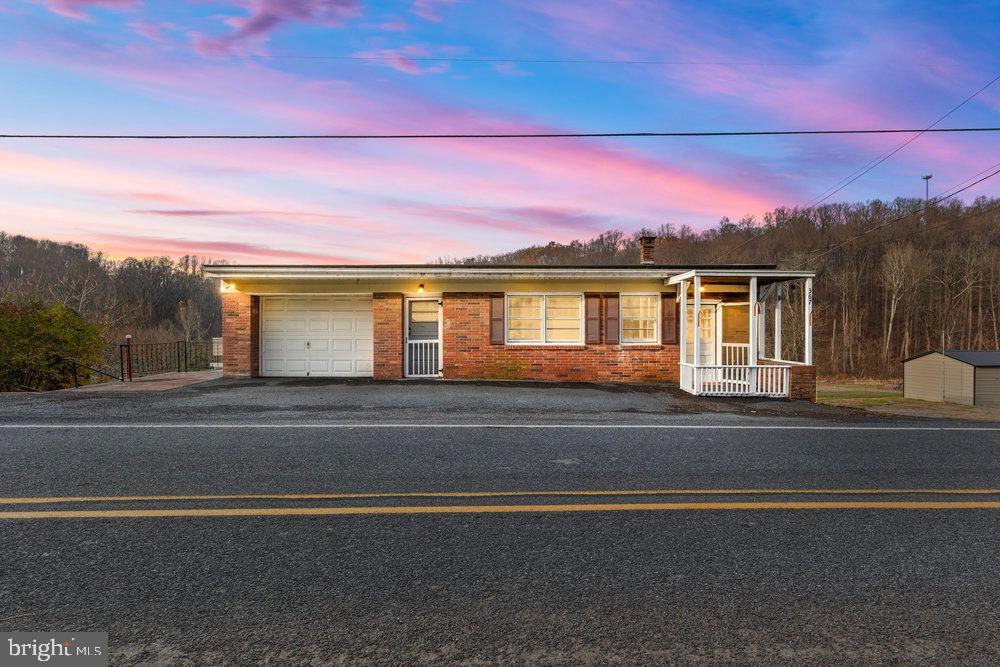 a view of a house with a city street and a mountain view