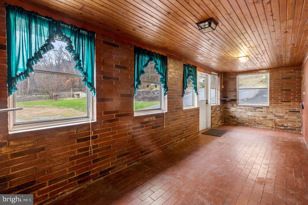 367 Bridge Valley Road Pequea, PA 17565 - Photo 6 of 51 a view of a porch with wooden floor and floor to ceiling window