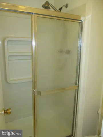 a bathroom with a glass shower door