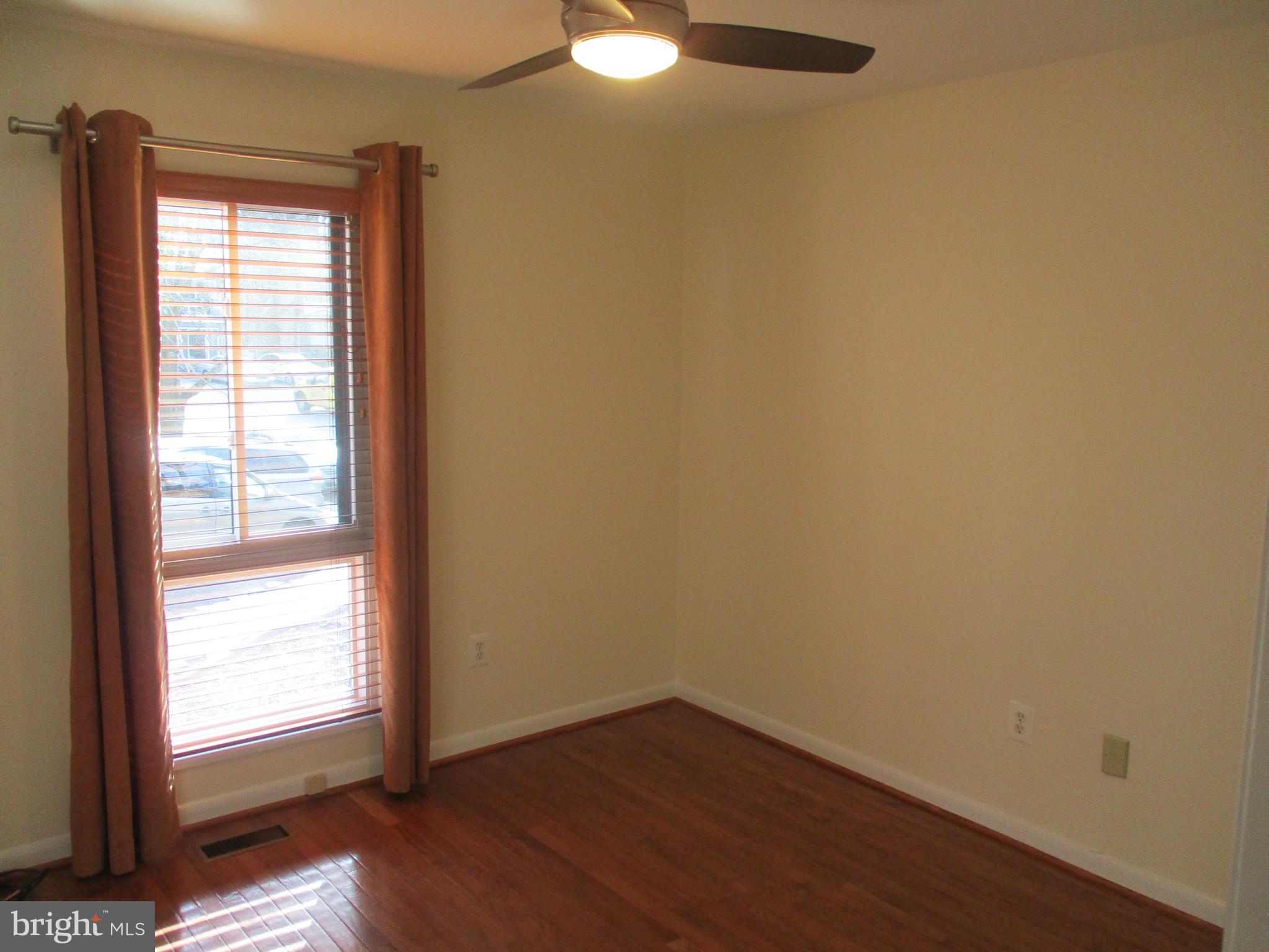 10357 Barcan Circle Columbia, MD 21044 - Photo 18 of 24 an empty room with wooden floor and windows