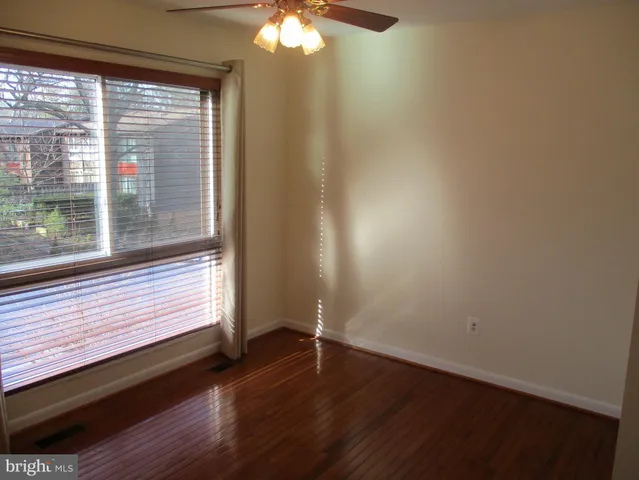 a view of a room with wooden floor and fan