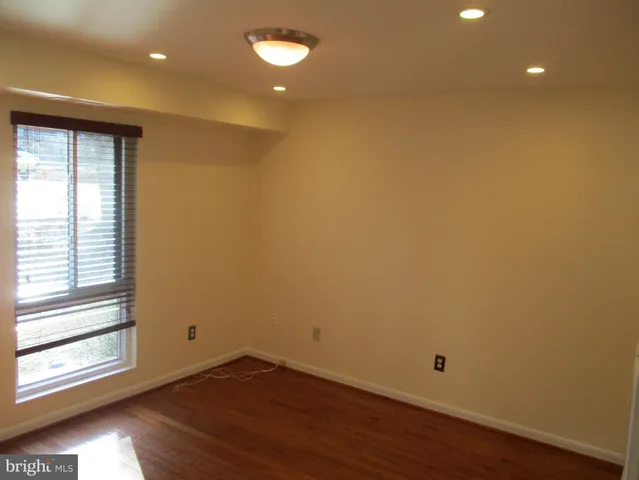 a view of a room with wooden floor and window
