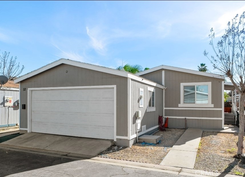 80 East Dawes, Unit 52 Perris, CA 92571 - Photo 1 of 21 a front view of a house with garden