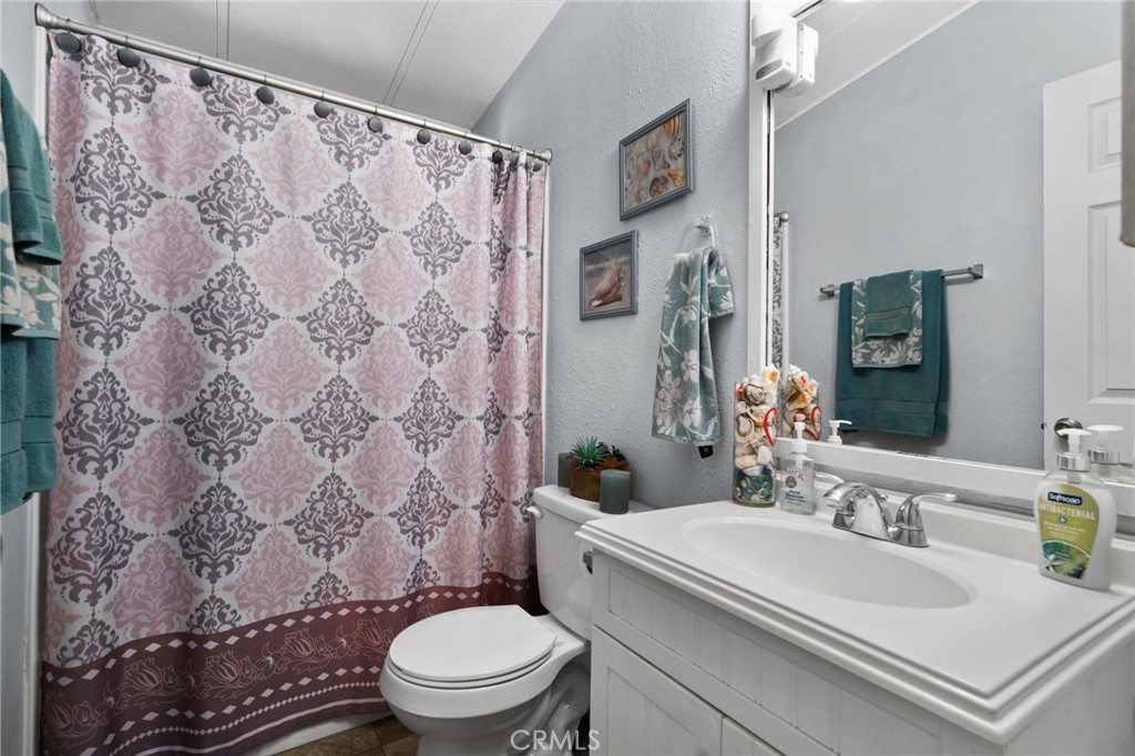 80 East Dawes, Unit 52 Perris, CA 92571 - Photo 19 of 21 a bathroom with a sink toilet and shower