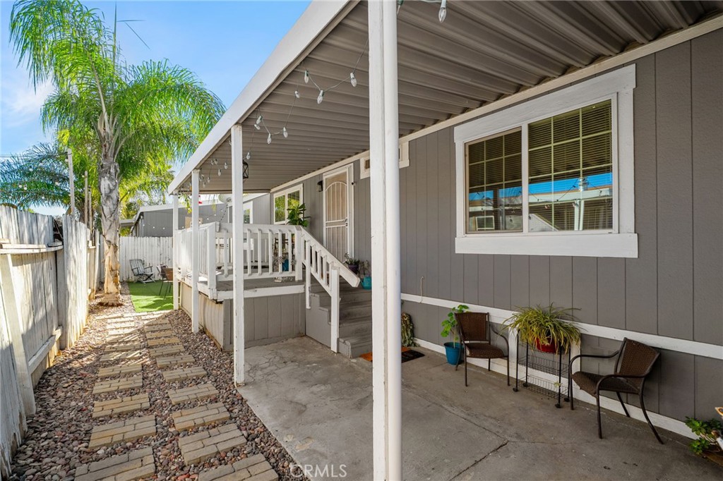 80 East Dawes, Unit 52 Perris, CA 92571 - Photo 2 of 21 a view of a patio with table and chairs potted plants and large tree
