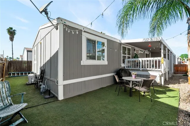 a view of a house with backyard and sitting area
