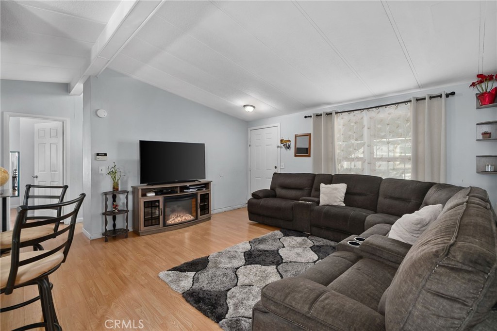 80 East Dawes, Unit 52 Perris, CA 92571 - Photo 5 of 21 a living room with furniture and a flat screen tv