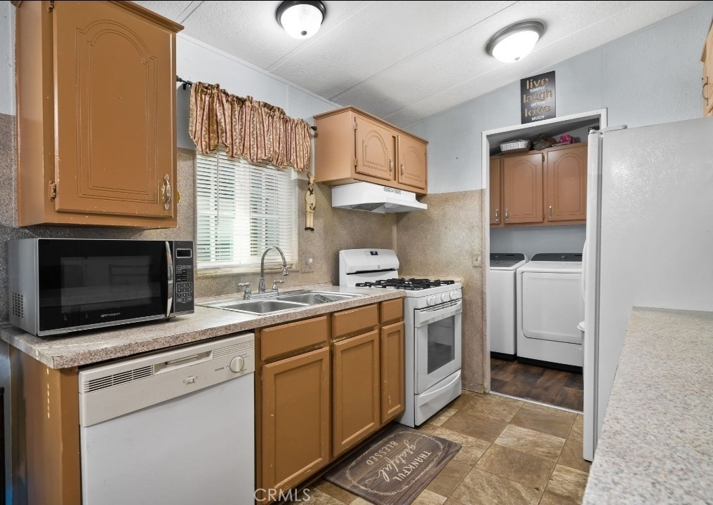 80 East Dawes, Unit 52 Perris, CA 92571 - Photo 7 of 21 a kitchen with stainless steel appliances granite countertop a sink stove and microwave