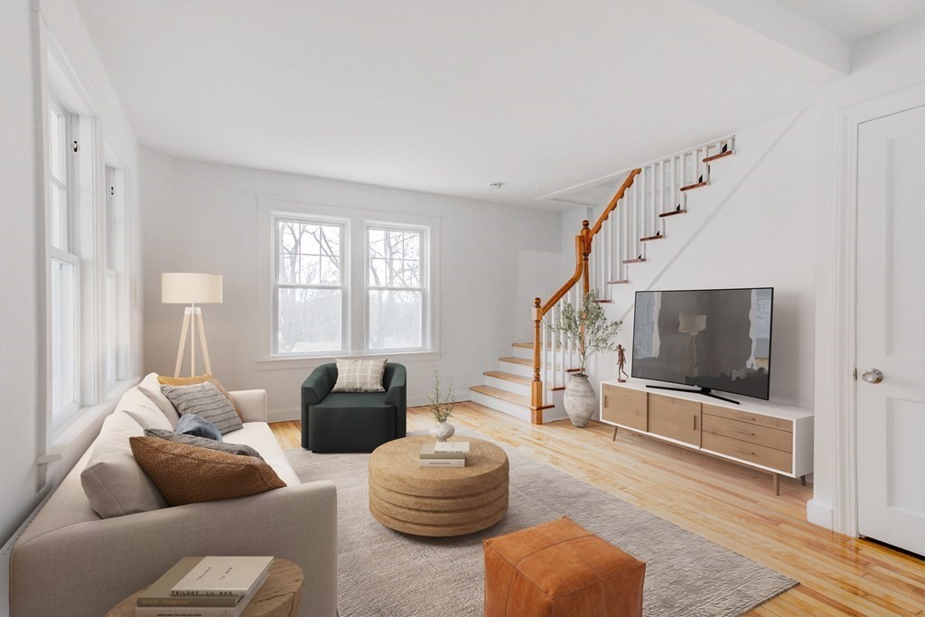 21 Alpine Trail Auburn, MA 01501 - Photo 2 of 10 a living room with furniture a flat screen tv and a large window