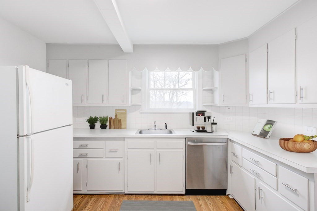 21 Alpine Trail Auburn, MA 01501 - Photo 4 of 10 a kitchen with white cabinets and white appliances