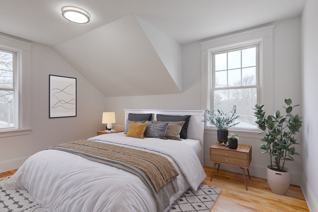 21 Alpine Trail Auburn, MA 01501 - Photo 5 of 10 a bedroom with a large bed and a potted plant