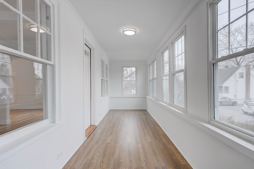 21 Alpine Trail Auburn, MA 01501 - Photo 9 of 10 a view of an entryway with wooden floor and windows