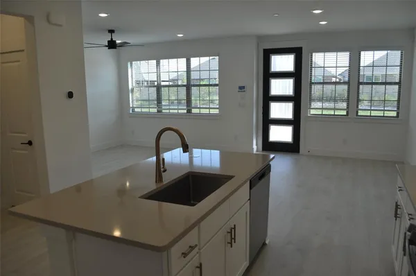 a kitchen with granite countertop a sink and a window