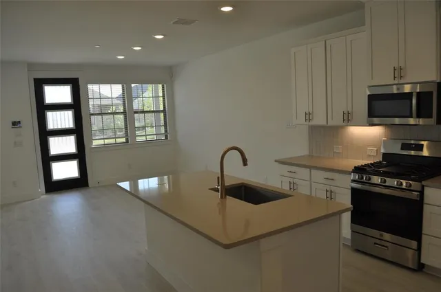 a kitchen with granite countertop a stove and a sink