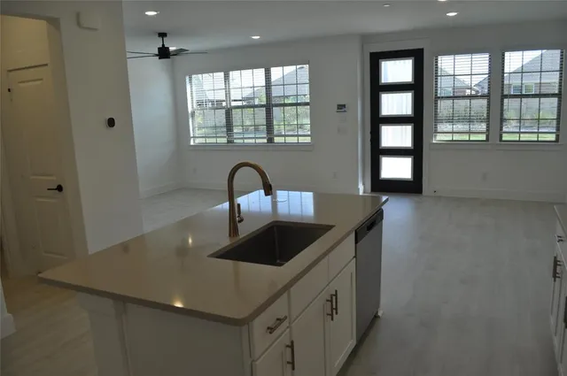 a kitchen with a sink a counter space and a window