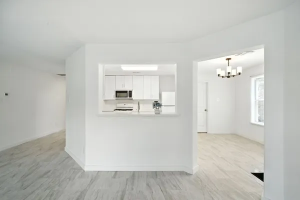 a view of kitchen with refrigerator and window