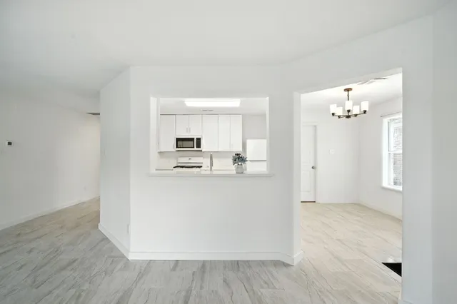 a view of kitchen with refrigerator and window