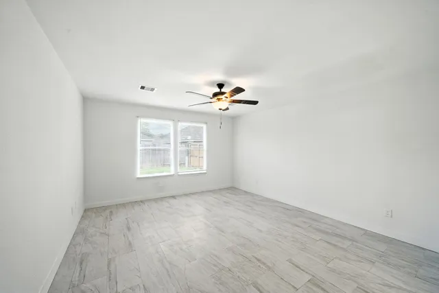 wooden floor in an empty room with a window