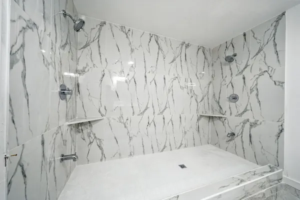 a bathroom with a sink a mirror and a shower