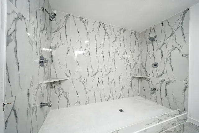 a bathroom with a sink a mirror and a shower