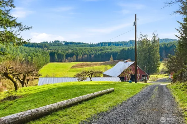 a view of a house with a yard and sitting area