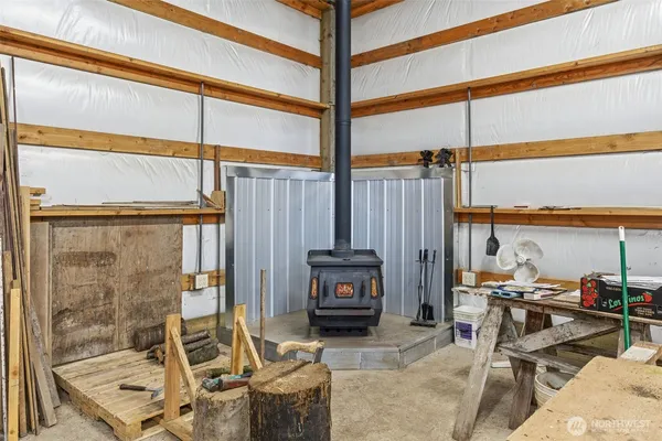 a living room filled with furniture and large windows