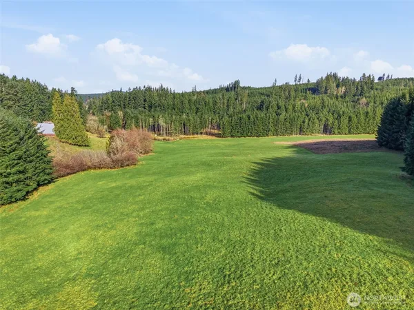 a view of building with garden and trees in the background