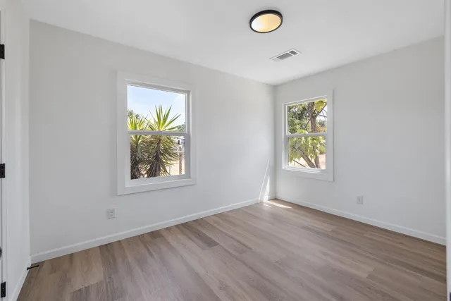 an empty room with windows and closet