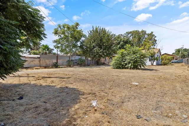 a view of dirt yard with a tree