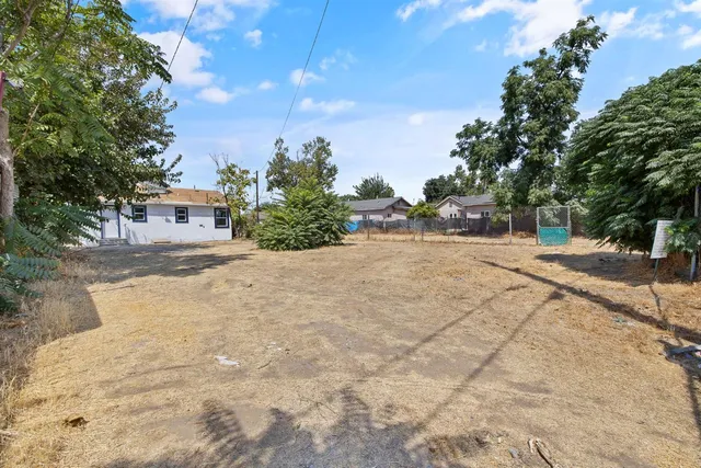 a view of road with large trees