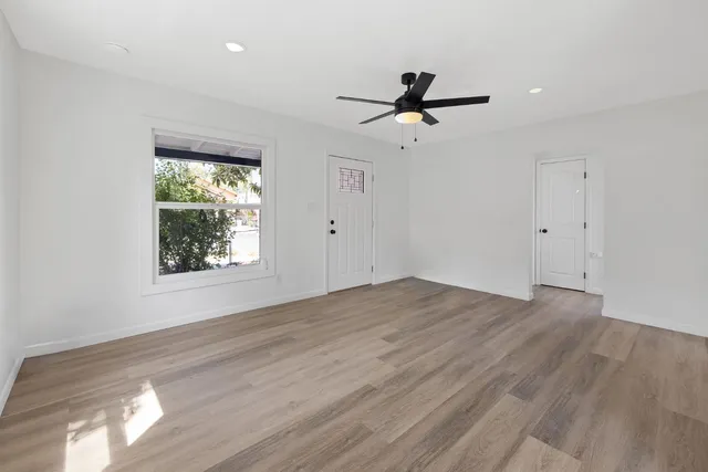 wooden floor in an empty room with a window