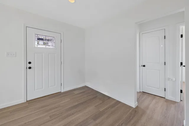 a view of a hallway with wooden floor