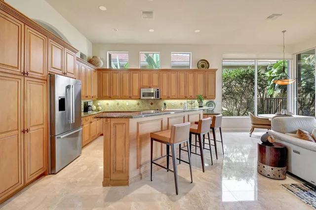 a dining room with furniture a chandelier and glass windows