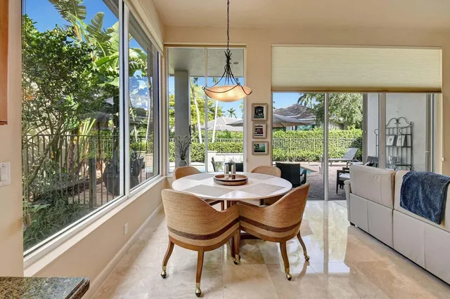 a kitchen with center island table and chairs in it
