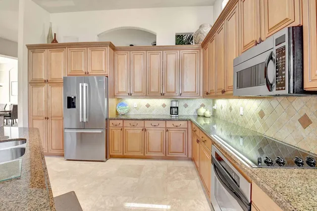 a kitchen with a table chairs and window